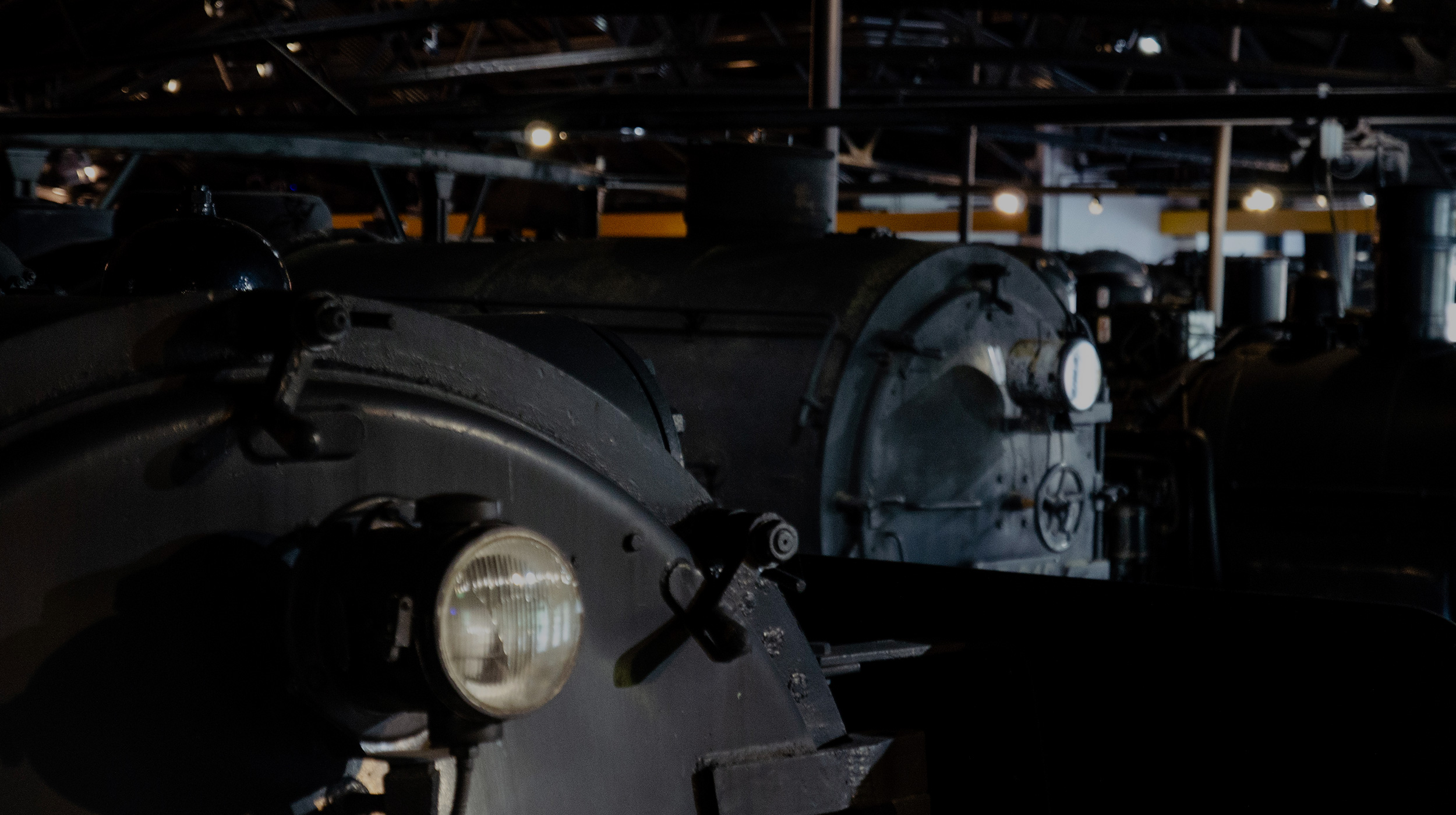 Fronts of the boilers of multiple steam locomotives in a row
